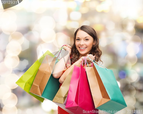 Image of smiling woman with colorful shopping bags