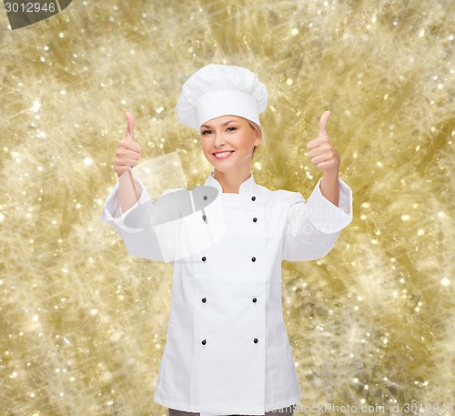 Image of smiling female chef showing thumbs up