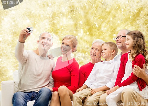 Image of smiling family with camera