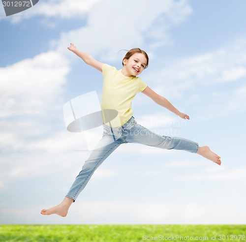 Image of smiling little girl jumping