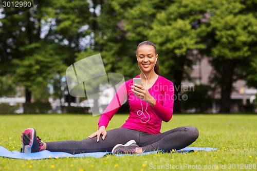 Image of smiling african american woman with smartphone