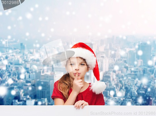 Image of smiling little girl in santa helper hat