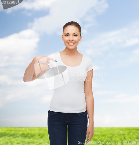 Image of smiling young woman in blank white t-shirt