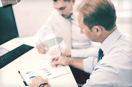 Image of businessmen with notebook on meeting