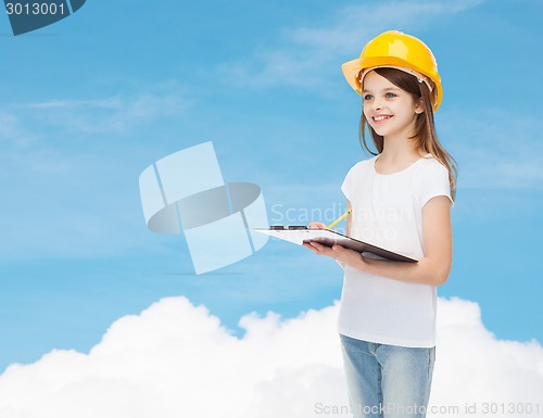 Image of smiling little girl in hardhat with clipboard