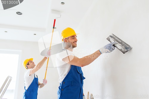 Image of group of builders with tools indoors