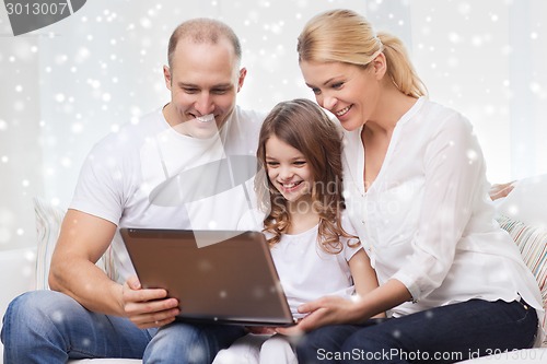 Image of smiling family with laptop at home