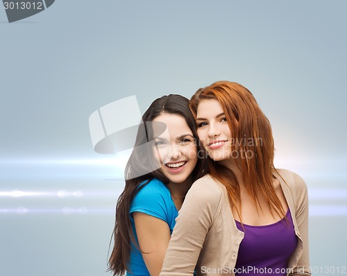 Image of smiling teenage girls hugging