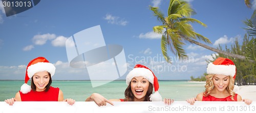 Image of women in santa helper hat with blank white board