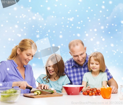 Image of happy family with two kids making dinner at home