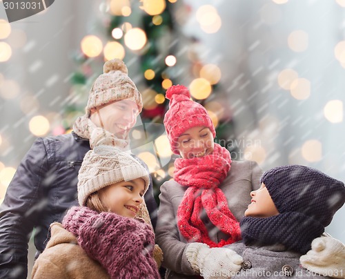 Image of happy family in winter clothes outdoors