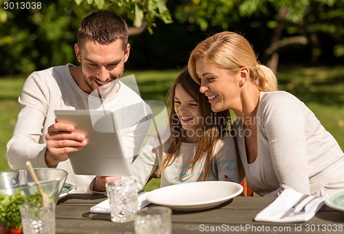 Image of happy family with tablet pc outdoors
