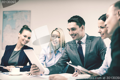 Image of business team with tablet pc having discussion