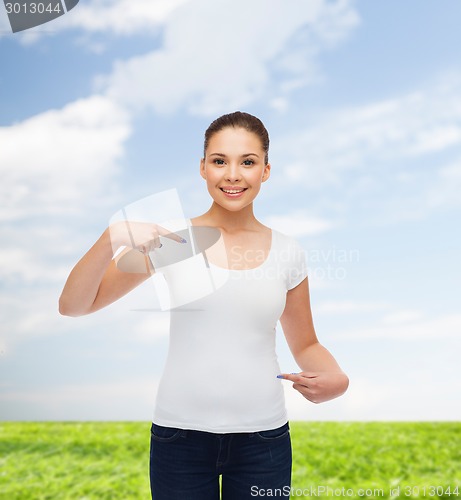 Image of smiling young woman in blank white t-shirt