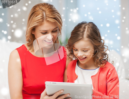 Image of mother and daughter with tablet pc at home
