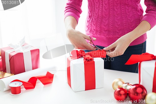 Image of close up of woman decorating christmas presents