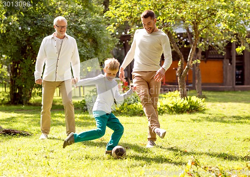 Image of happy family playing football outdoors