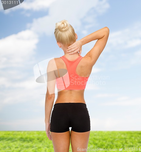 Image of sporty woman touching her neck