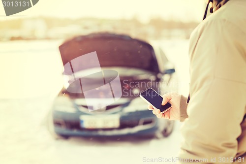 Image of closeup of man with broken car and smartphone