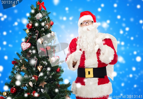 Image of santa claus with bag and christmas tree