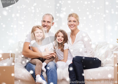 Image of smiling parents and two little girls at new home