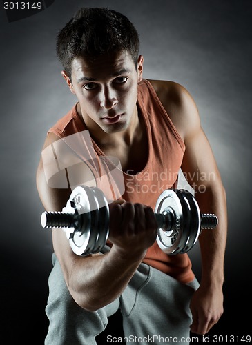 Image of young man with dumbbell