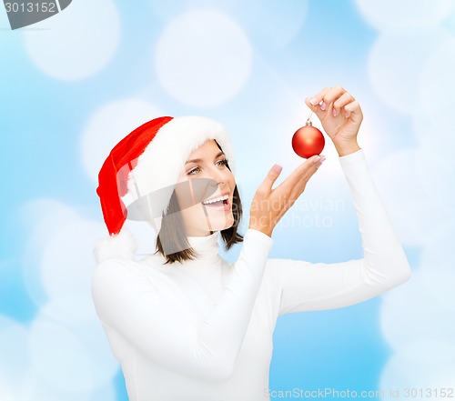 Image of woman in santa helper hat with christmas ball