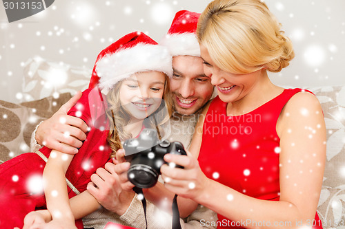 Image of happy family with digital camera at home