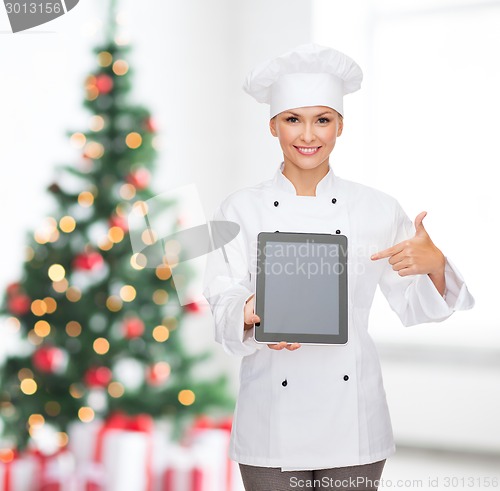 Image of smiling female chef with tablet pc blank screen