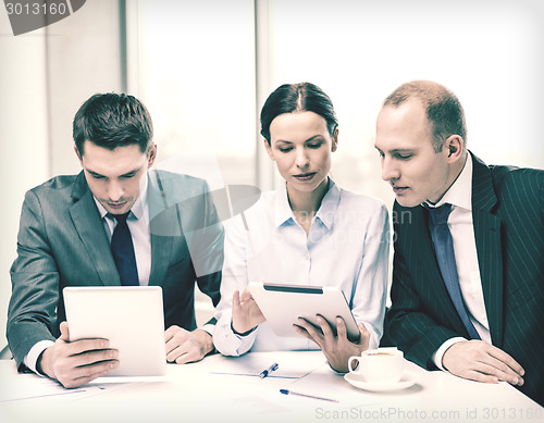 Image of business team with tablet pc having discussion