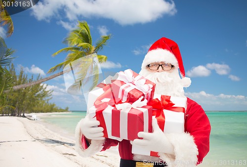 Image of man in costume of santa claus with gift boxes