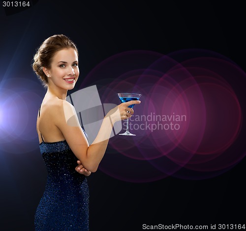 Image of smiling woman holding cocktail