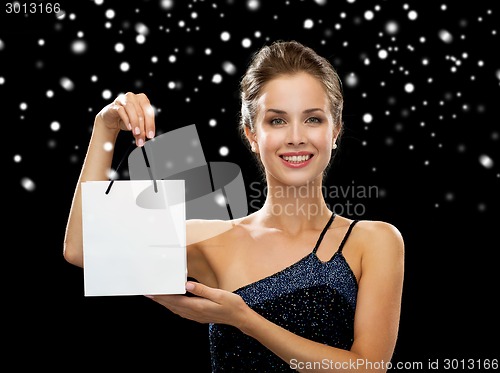 Image of smiling woman with white blank shopping bag