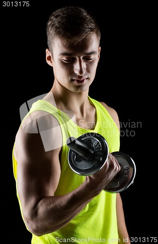 Image of young man with dumbbell