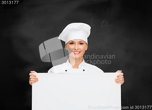 Image of smiling female chef with white blank board