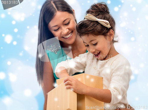 Image of happy mother and child girl with gift box