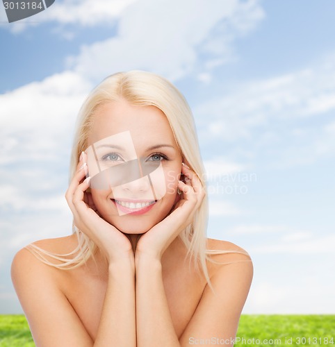 Image of beautiful woman touching her face skin