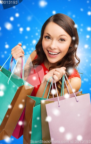 Image of smiling woman with colorful shopping bags