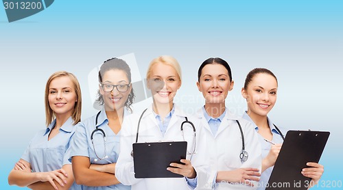 Image of smiling female doctors and nurses with stethoscope