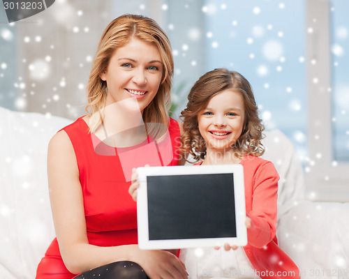 Image of mother and daughter with tablet pc at home