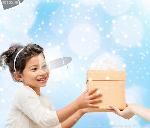 Image of smiling little girl with gift box