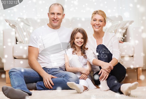 Image of smiling parents and little girl at home