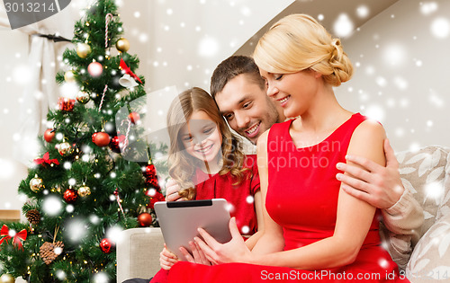 Image of smiling family with tablet pc at home