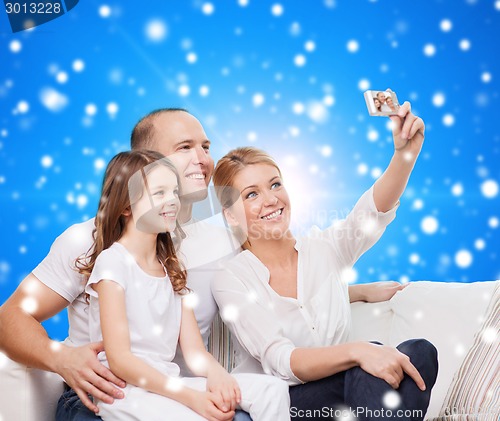 Image of happy family with camera at home