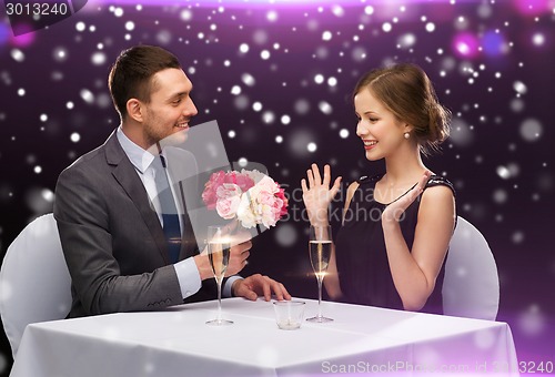 Image of smiling couple course at restaurant