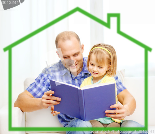 Image of smiling father and daughter reading book at home