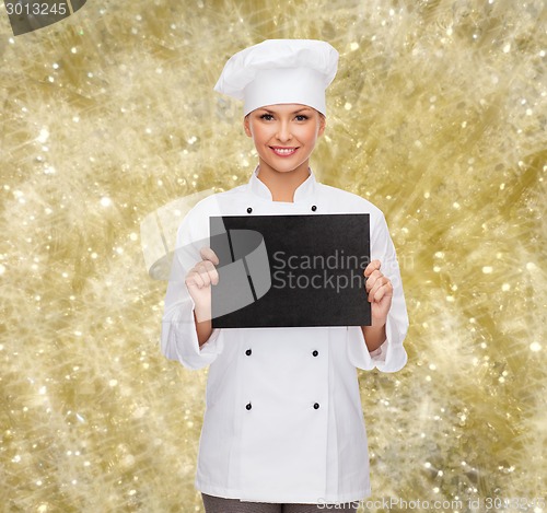 Image of smiling female chef with black blank paper