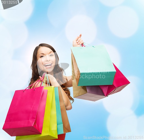 Image of smiling woman with colorful shopping bags