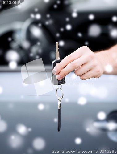 Image of close up of man with car key outdoors