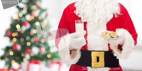 Image of close up of santa claus with milk and cookies